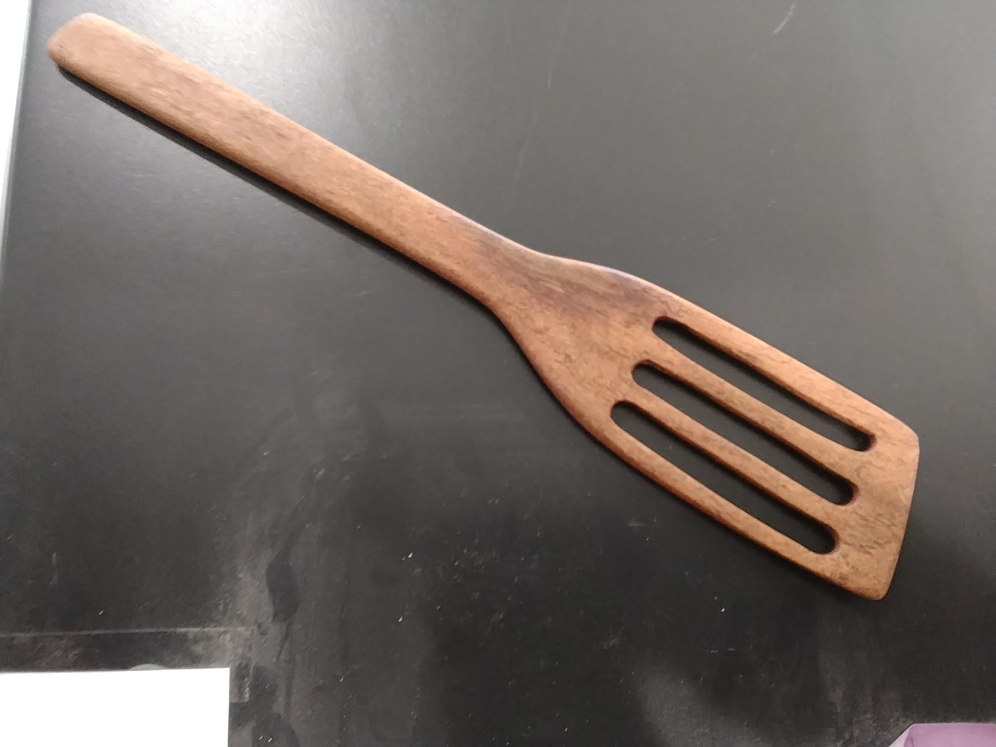 Wooden slotted kitchen utensil